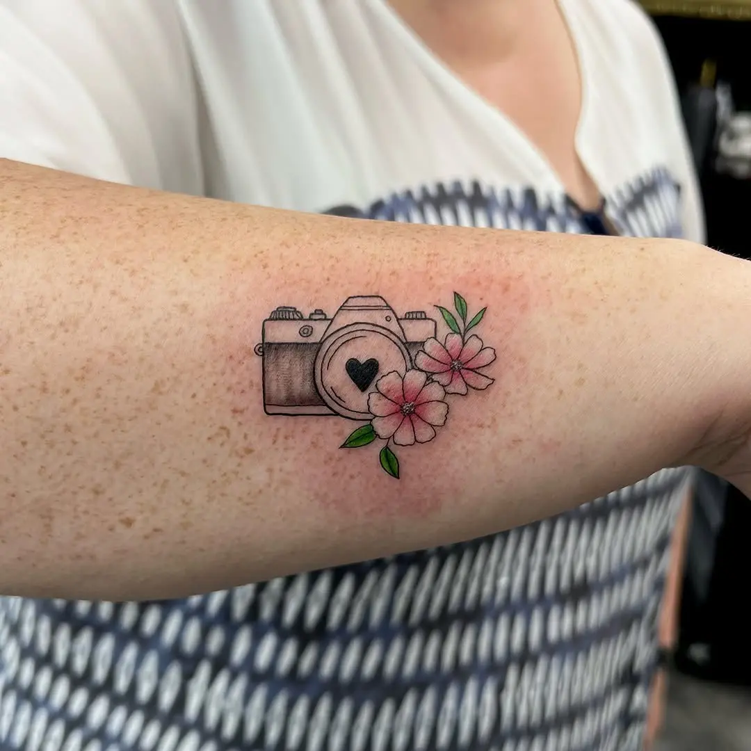 Charming floral camera tattoo design on arm