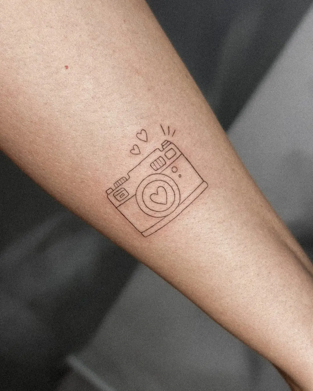 Charming camera tattoo with heart details