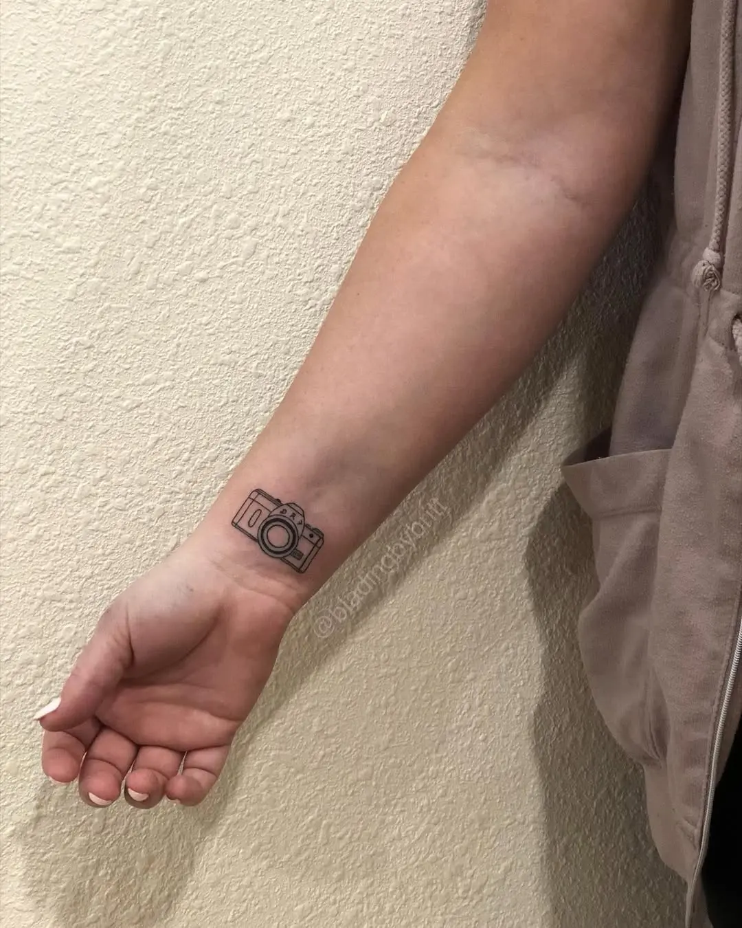 Minimalist Camera Tattoo on the Forearm