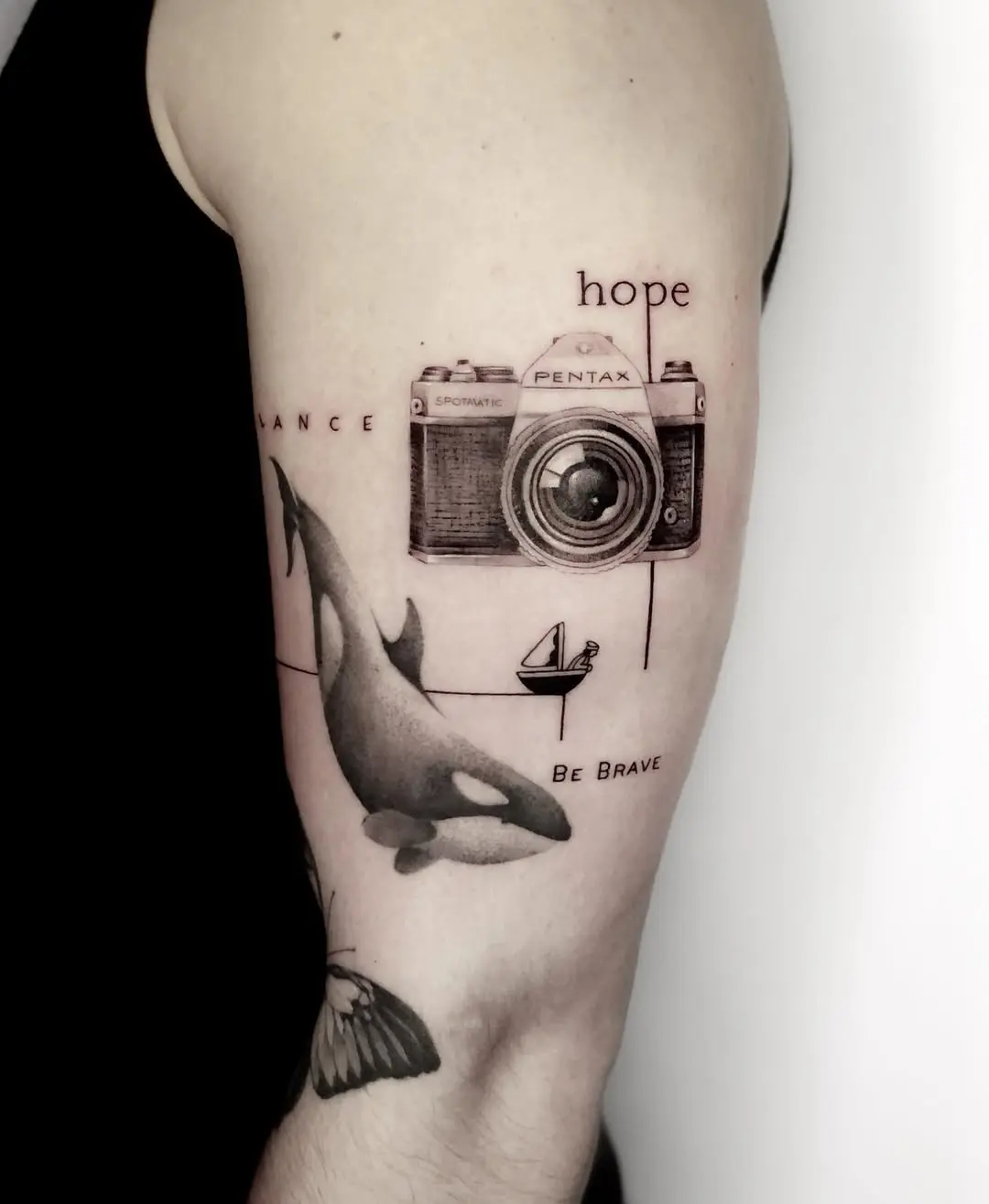 A striking camera tattoo with ocean elements