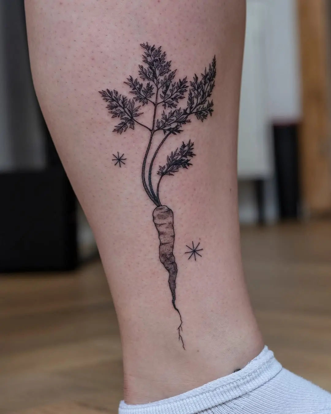 Elegant carrot tattoo with delicate details