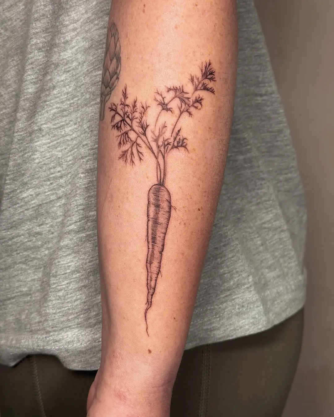 Beautifully detailed carrot tattoo on arm