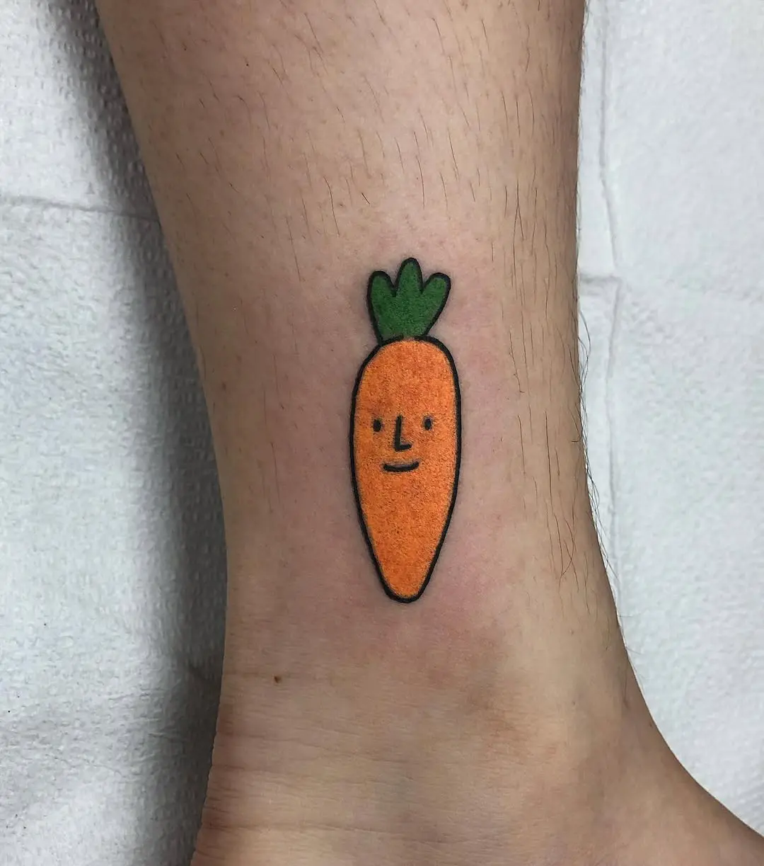 Adorable carrot tattoo with a quirky face