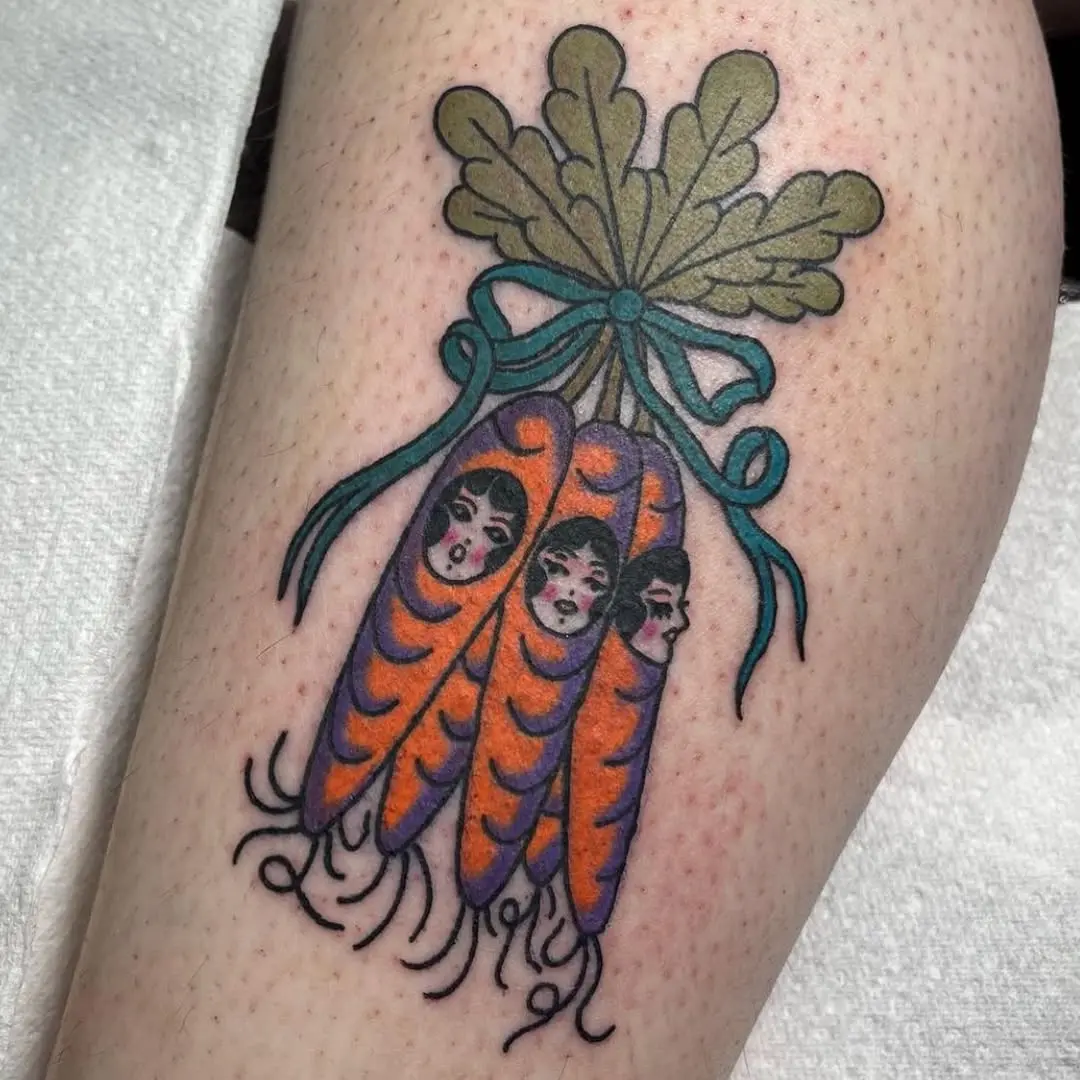 Whimsical carrot tattoo with artistic faces