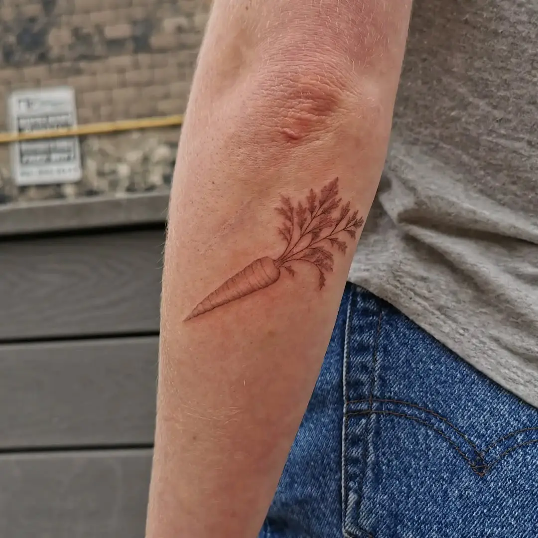Elegant vintage carrot tattoo design on arm