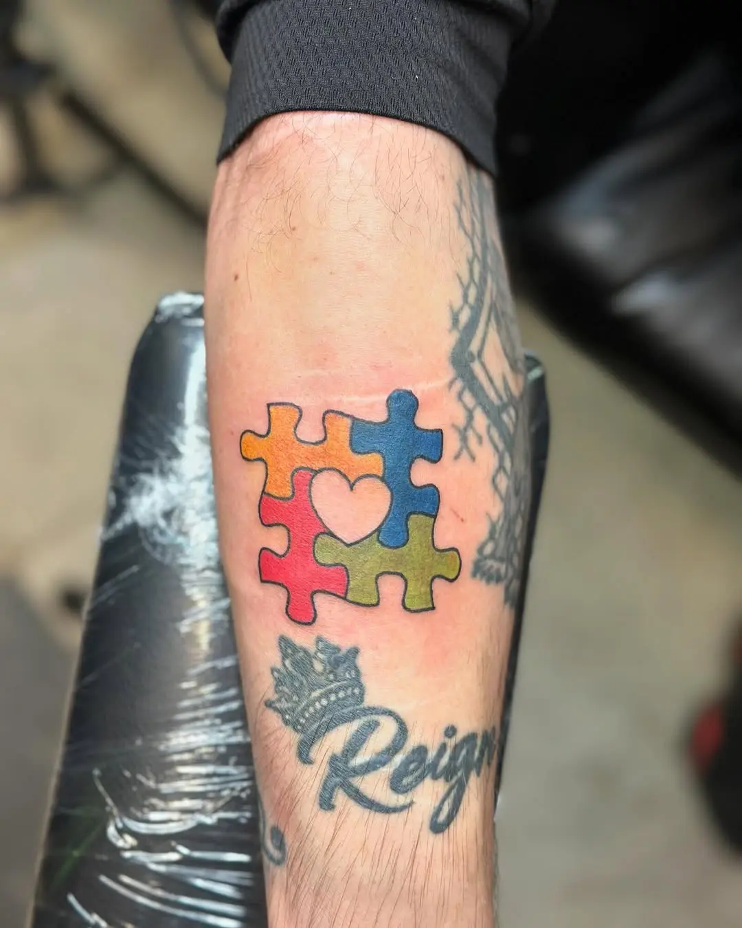 Vibrant puzzle piece tattoo with heart design