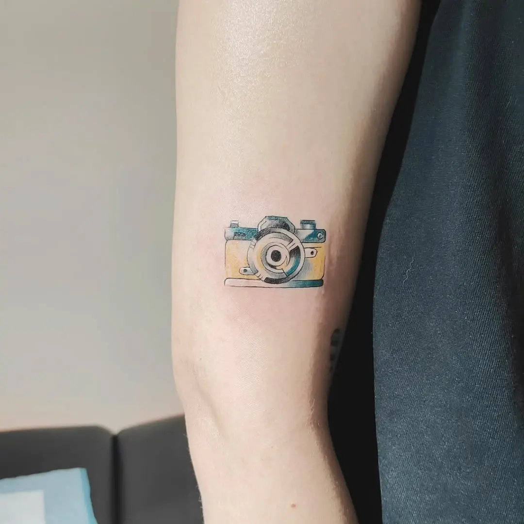 Stylish camera tattoo with vibrant colors