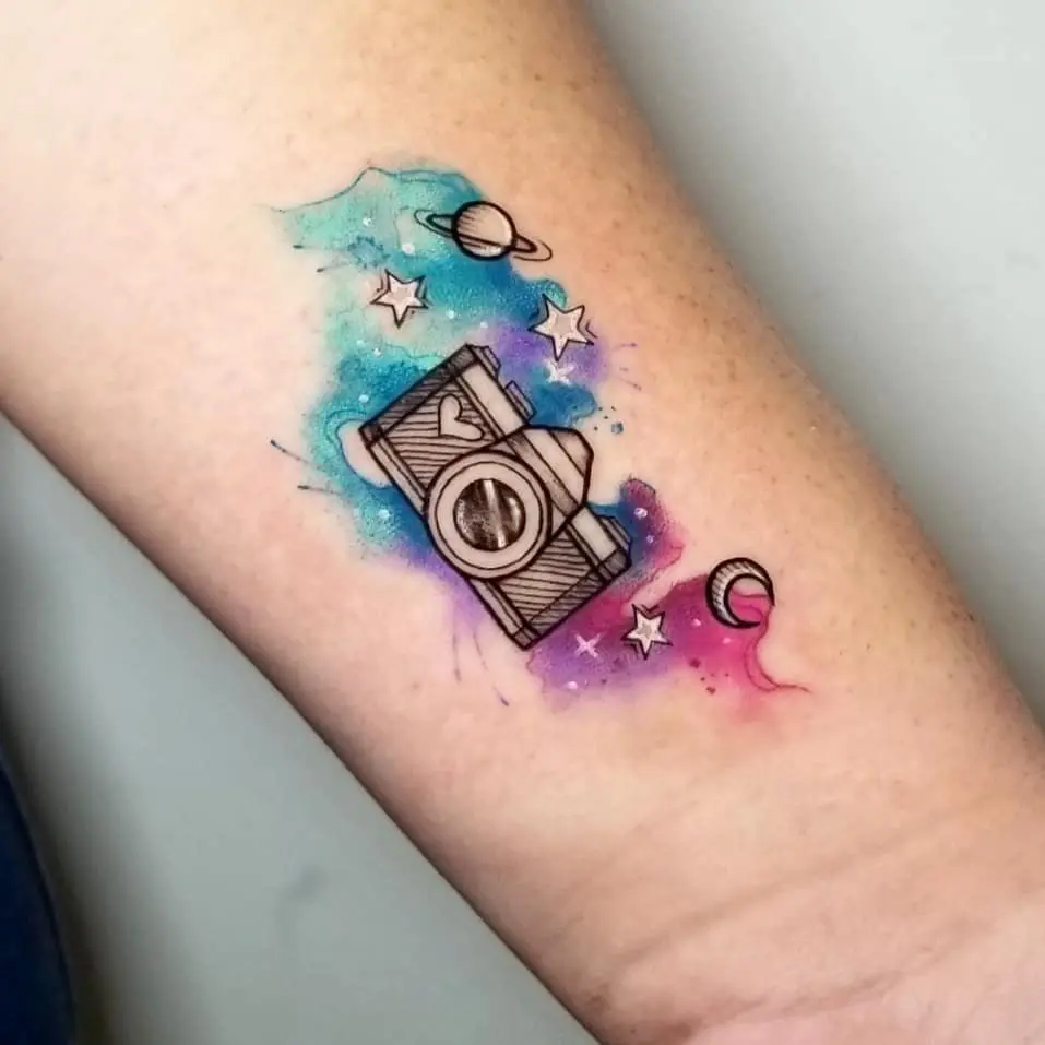 Vibrant camera tattoo with cosmic elements