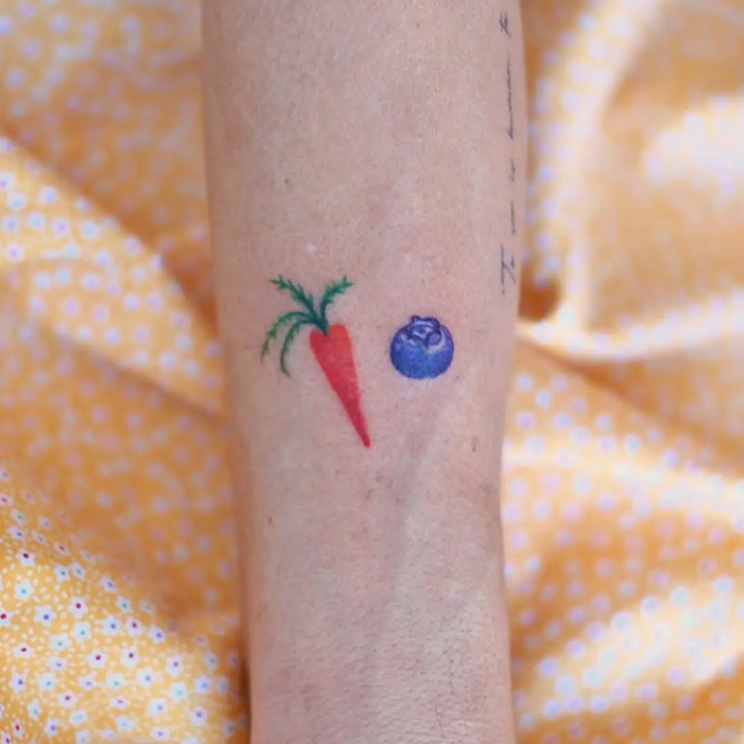 Charming carrot and blueberry tattoo design
