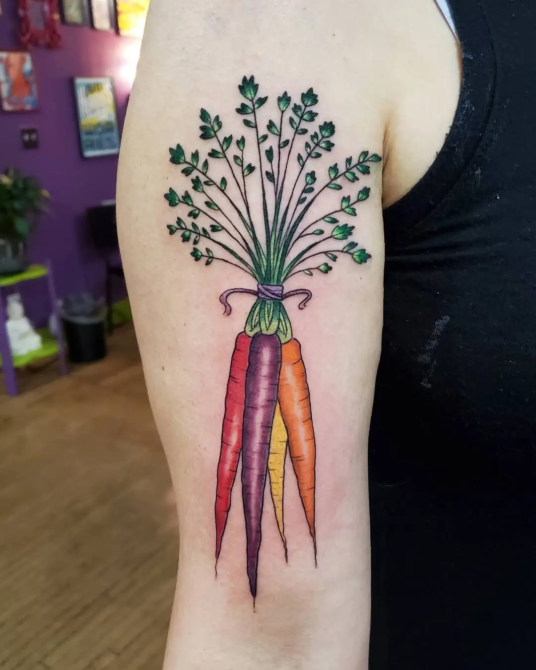 Vibrant carrot tattoo with leafy top