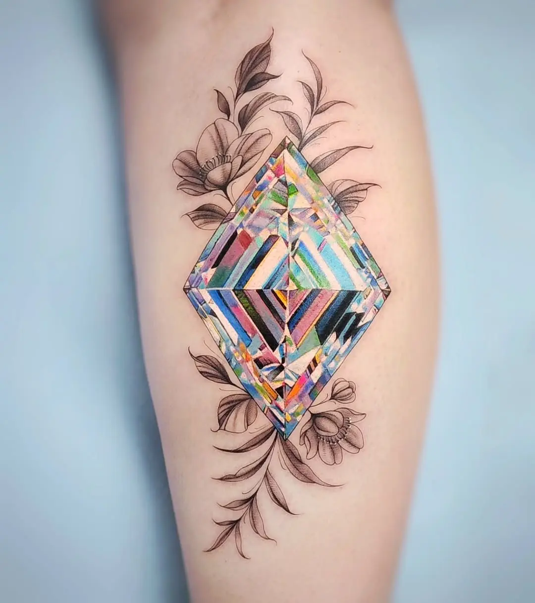 Vibrant diamond tattoo with floral accents