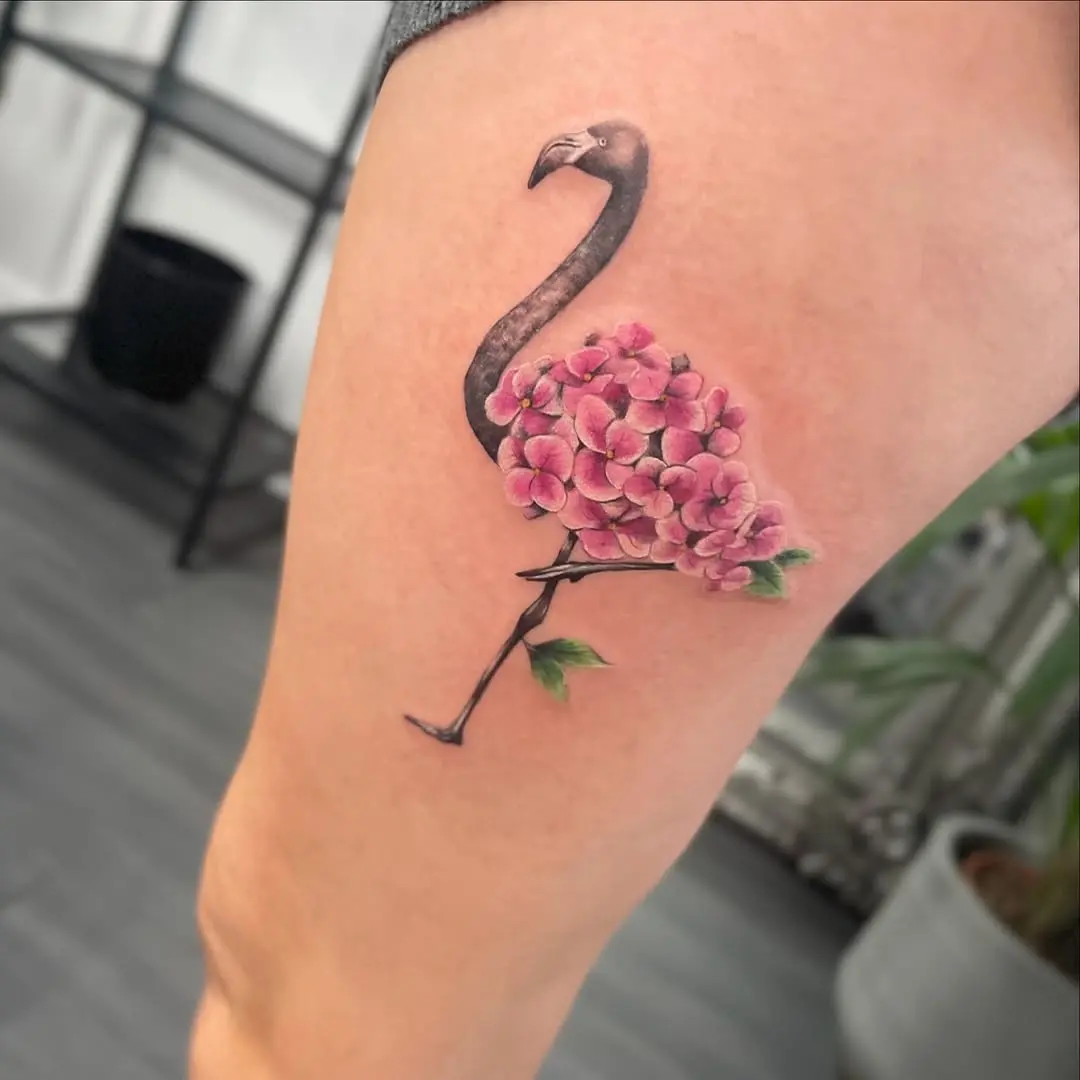 Stylish flamingo tattoo with vibrant florals
