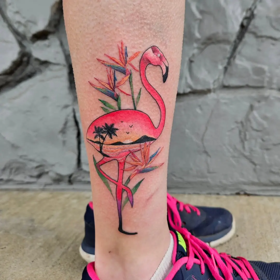 Bright flamingo tattoo with tropical floral elements