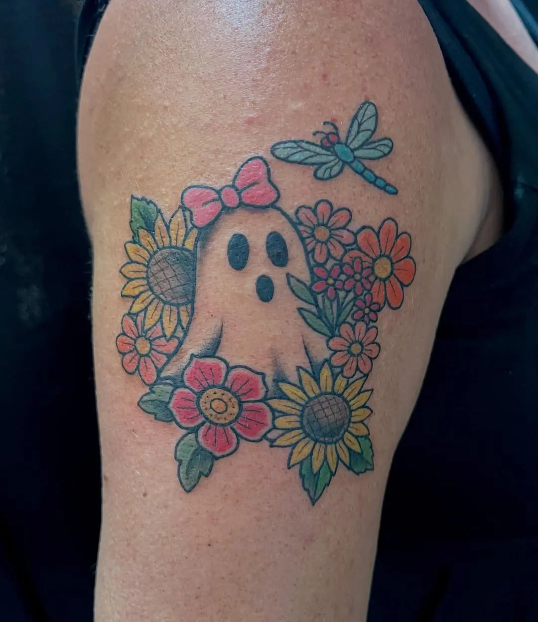 Charming ghost tattoo surrounded by flowers