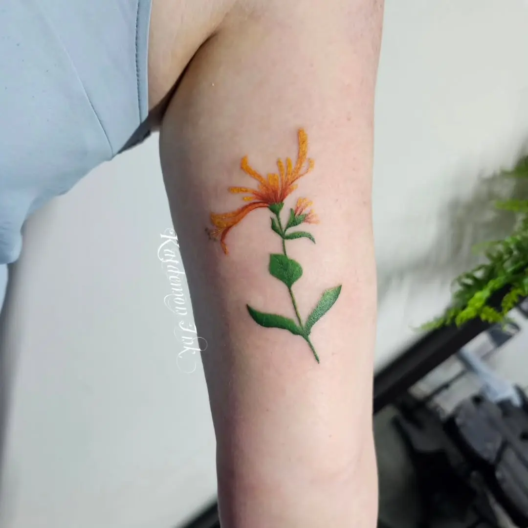 Stunning honeysuckle tattoo with vibrant colors