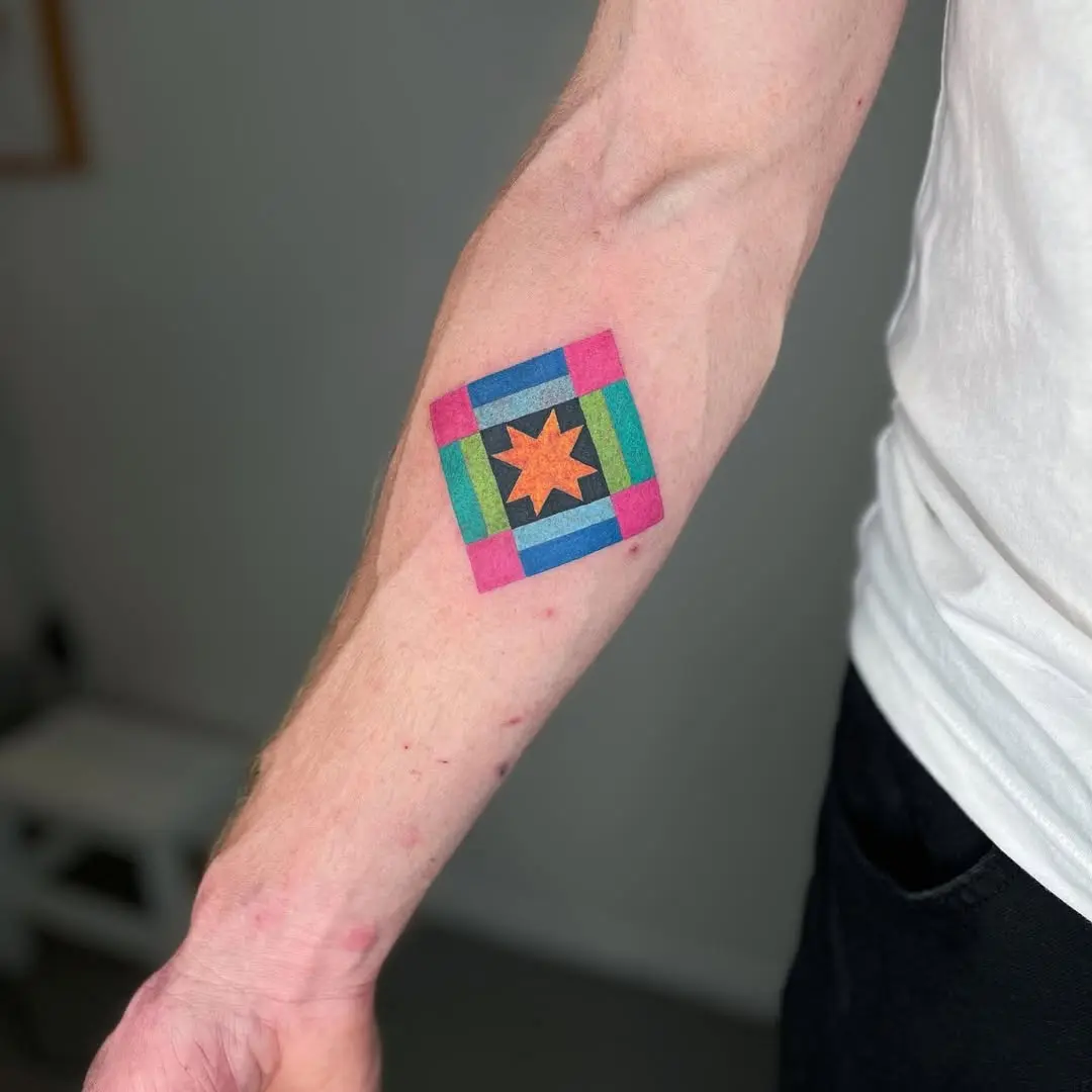 Vibrant quilt tattoo featuring a star centerpiece