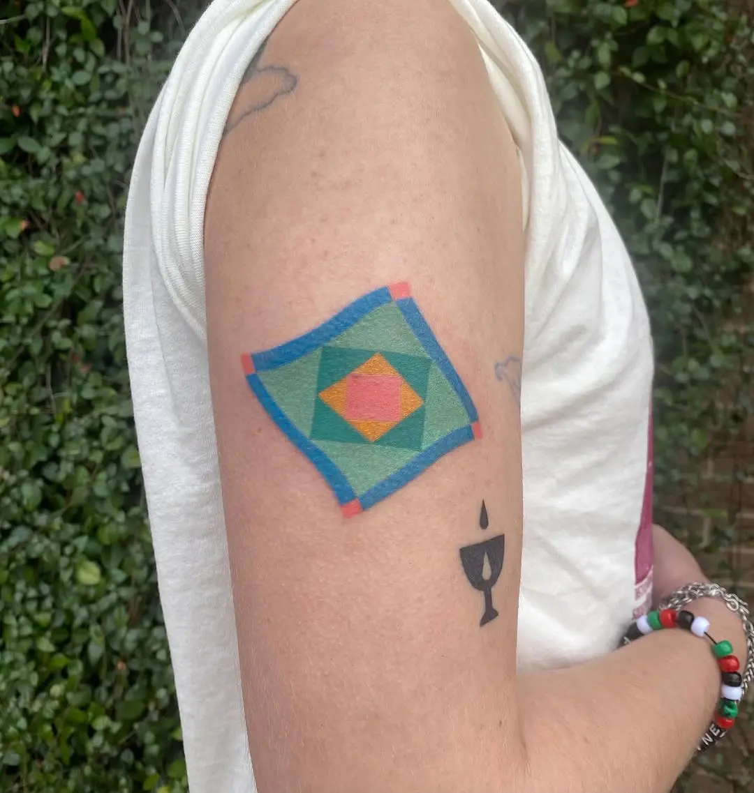 Vibrant quilt tattoo with geometric patterns
