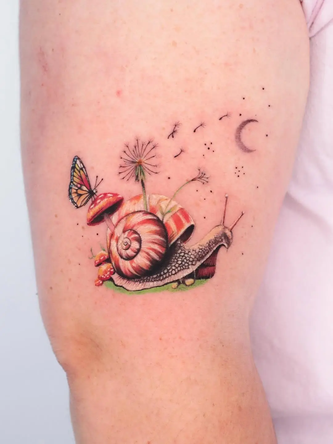 Charming snail tattoo with whimsical elements