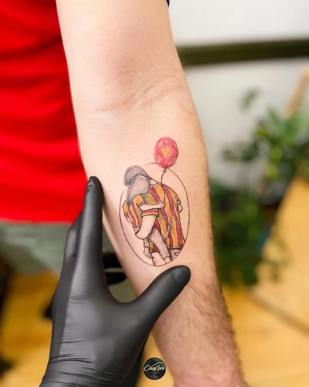 Vibrant tattoo of a soccer player with balloon