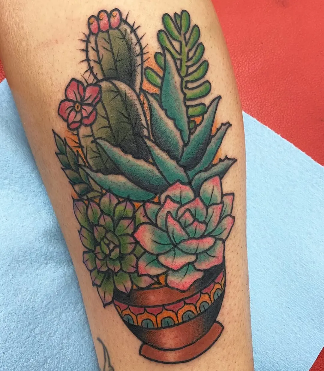 Vibrant succulent and cactus tattoo in a pot
