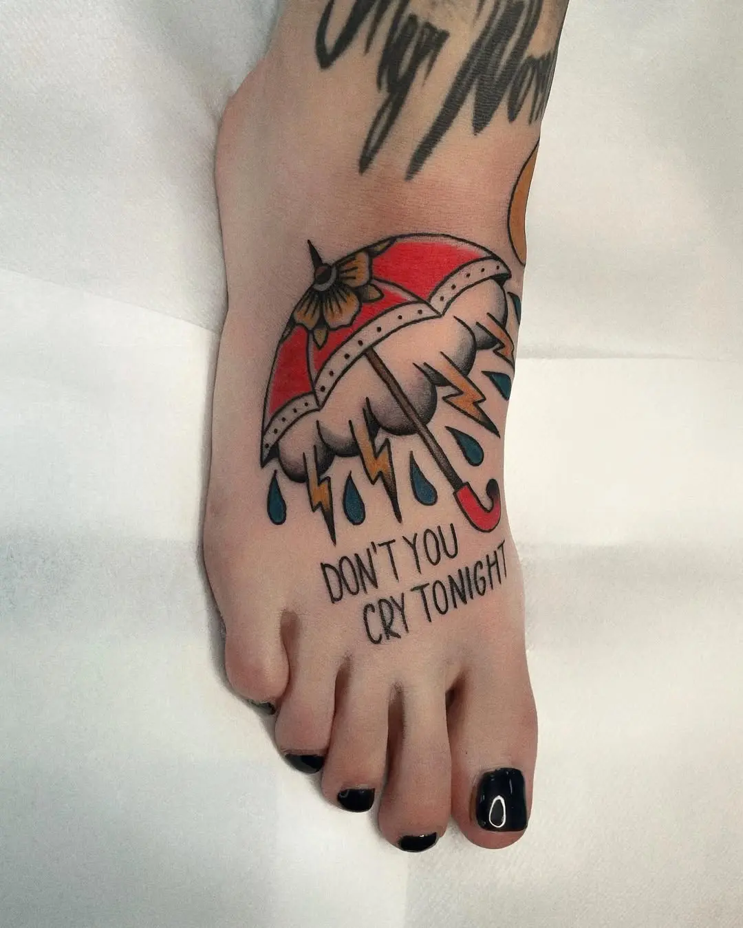 Playful umbrella tattoo with a heartfelt message