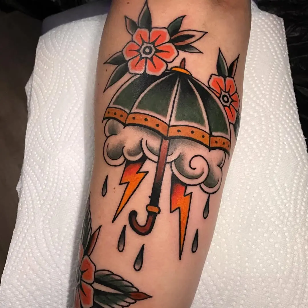 Vibrant umbrella tattoo with floral accents