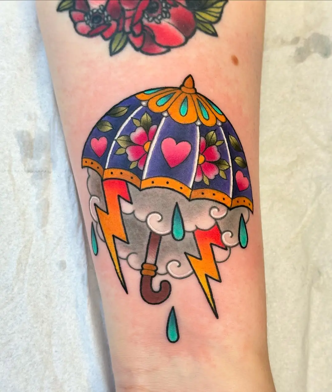Vibrant umbrella tattoo with floral and lightning elements