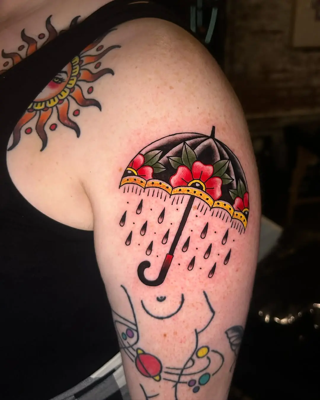 Vibrant umbrella tattoo with floral design
