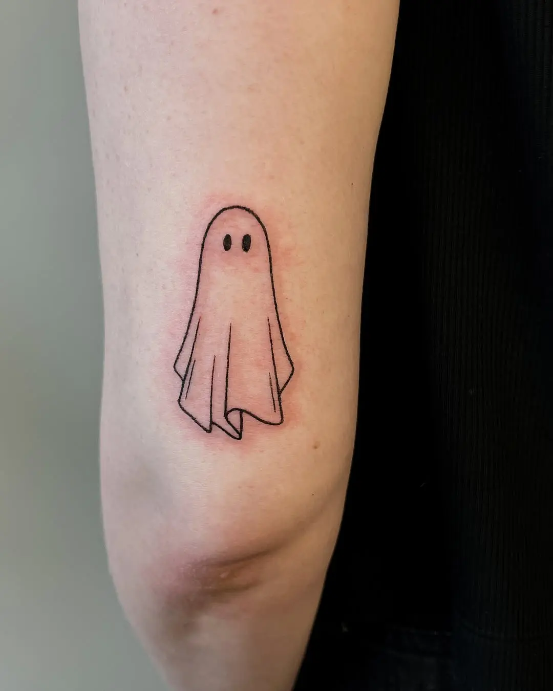 Charming cartoon ghost tattoo for playful vibes