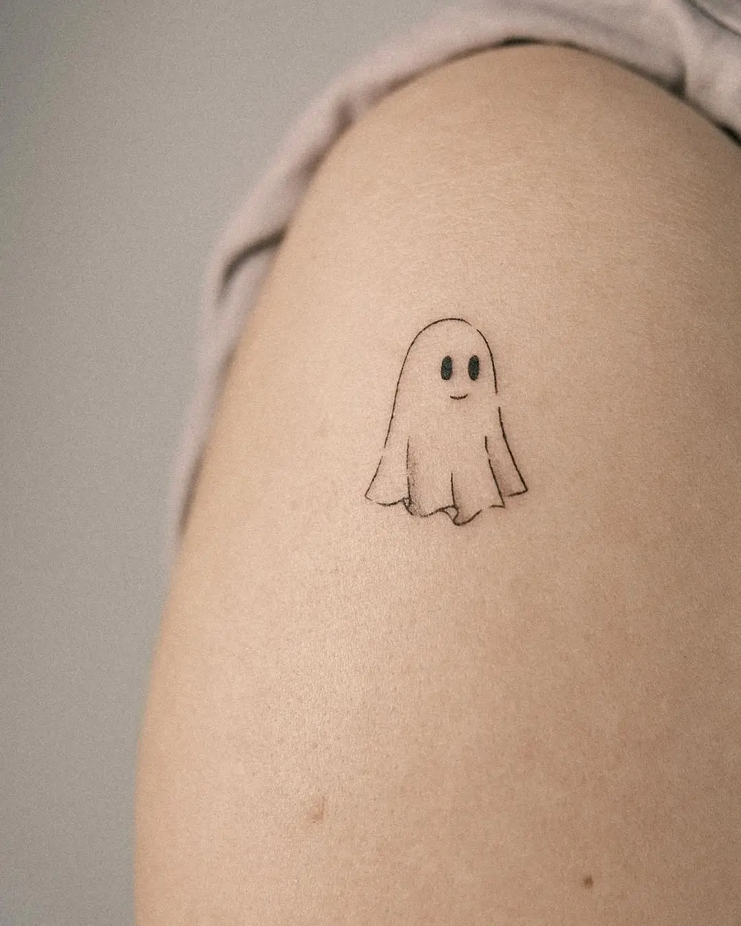 Charming minimalist ghost tattoo design