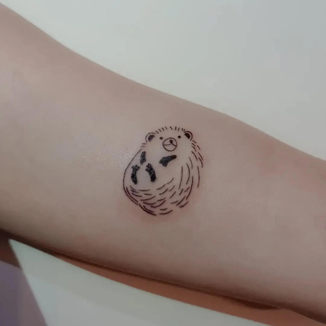 Charming hedgehog tattoo exuding playful vibes
