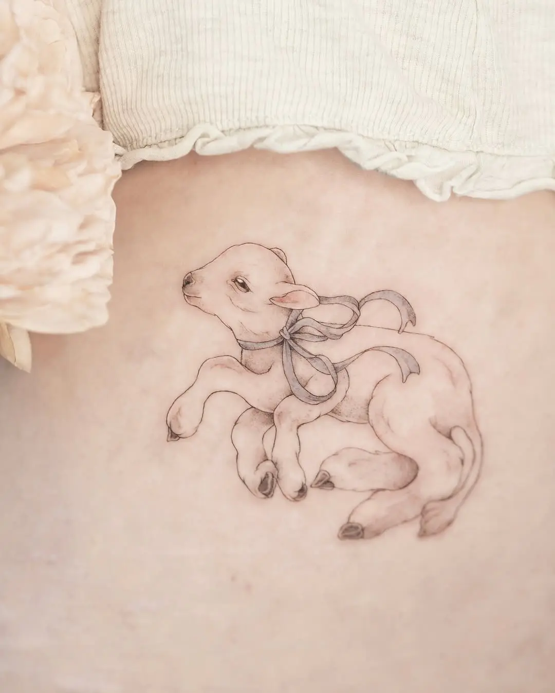 Adorable lamb tattoo displaying grace and charm