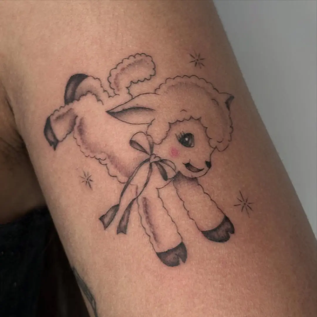 Charming and whimsical lamb tattoo with a bow