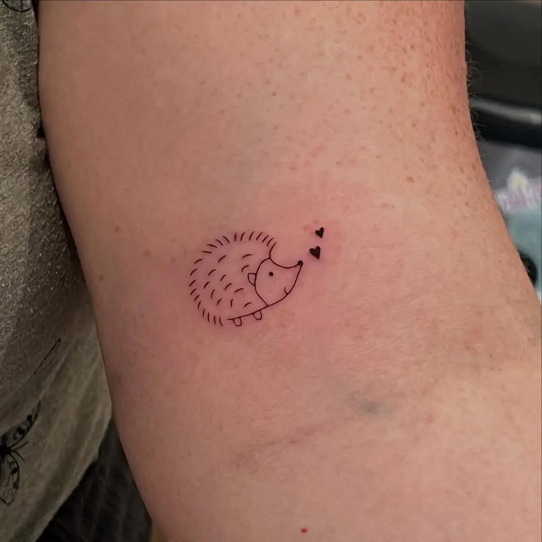Charming hedgehog tattoo with love hearts