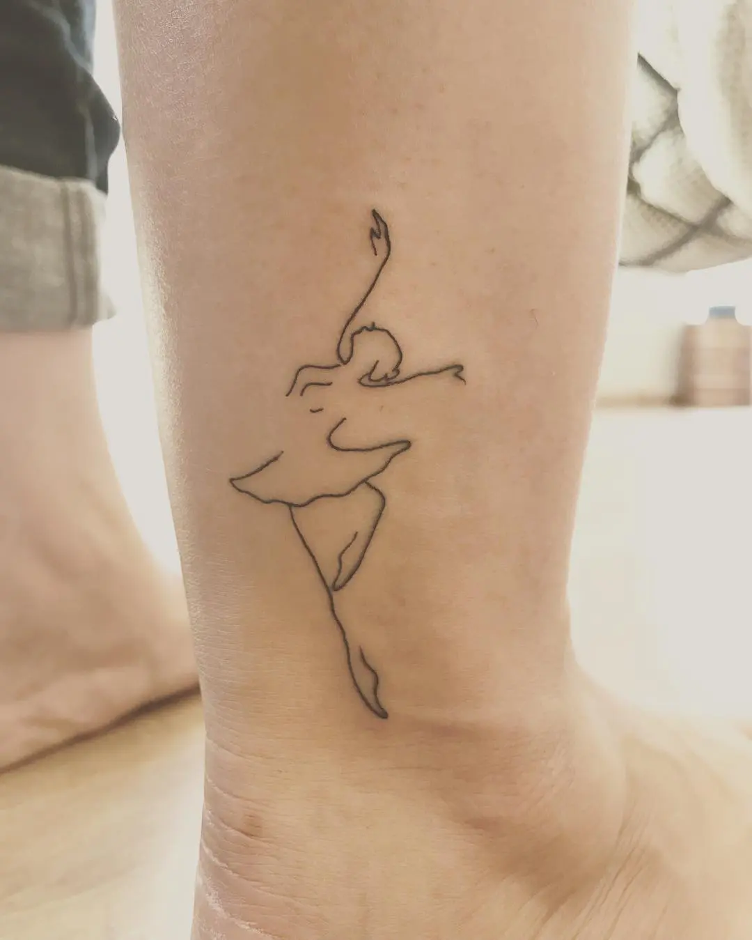 Elegant ballet dancer tattoo in clean lines