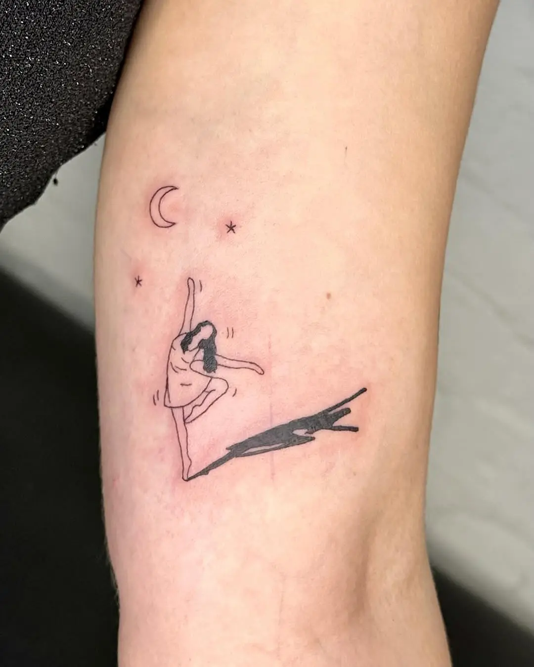 A graceful ballet dancer under the moon