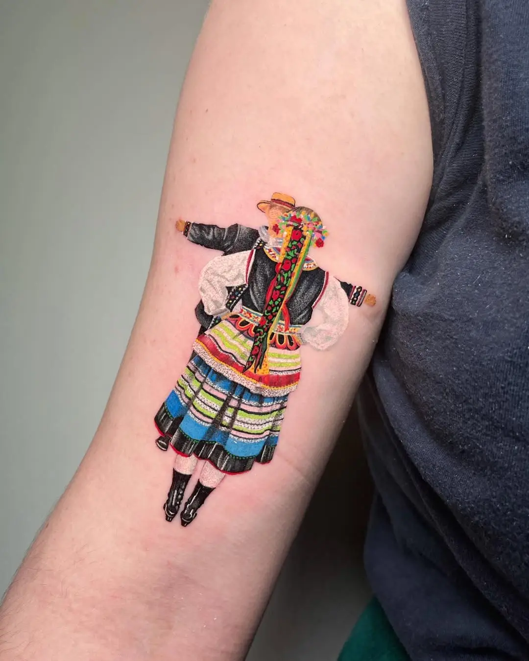 Traditional dancer tattoo showcasing cultural artistry