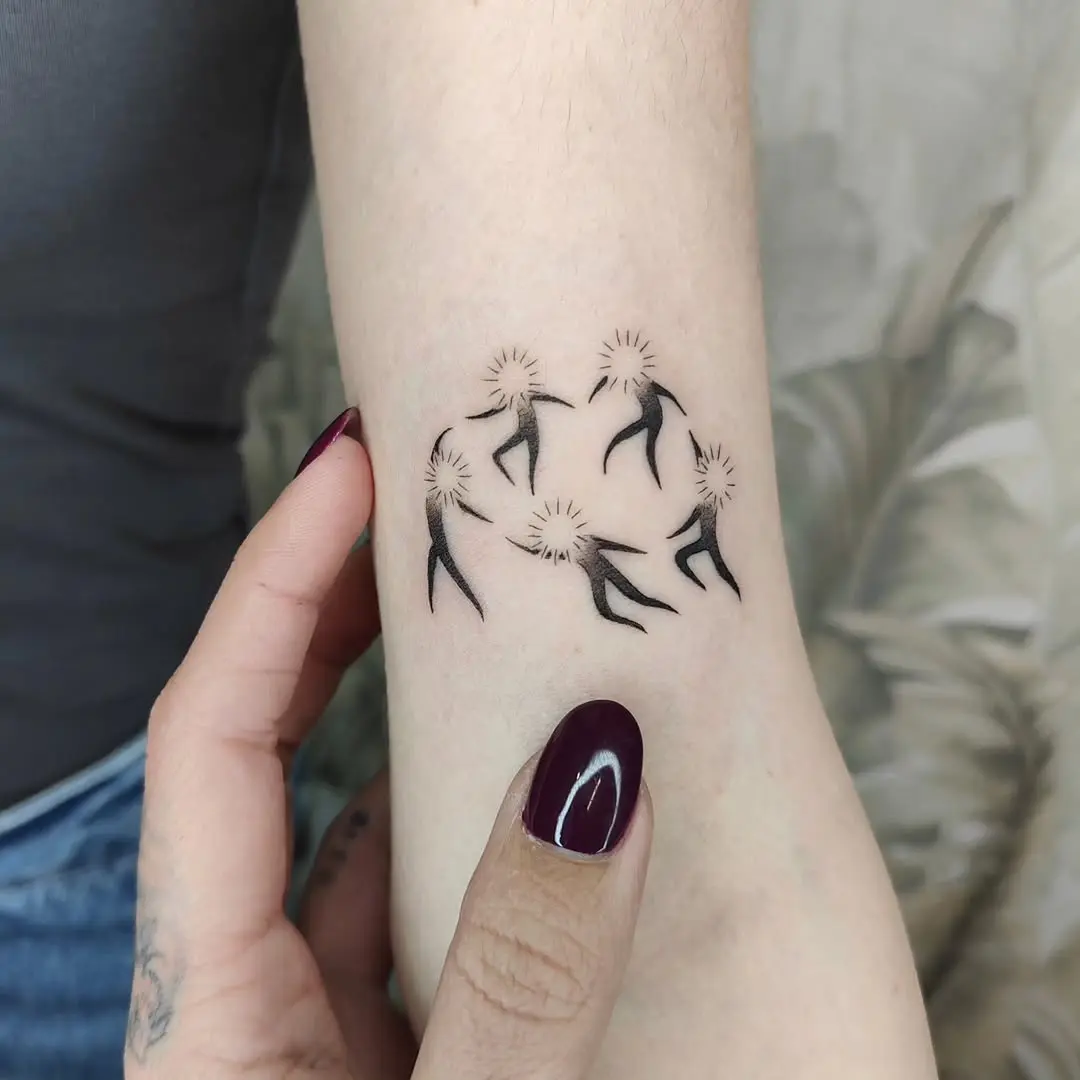 Elegant dancers forming a joyful circle tattoo