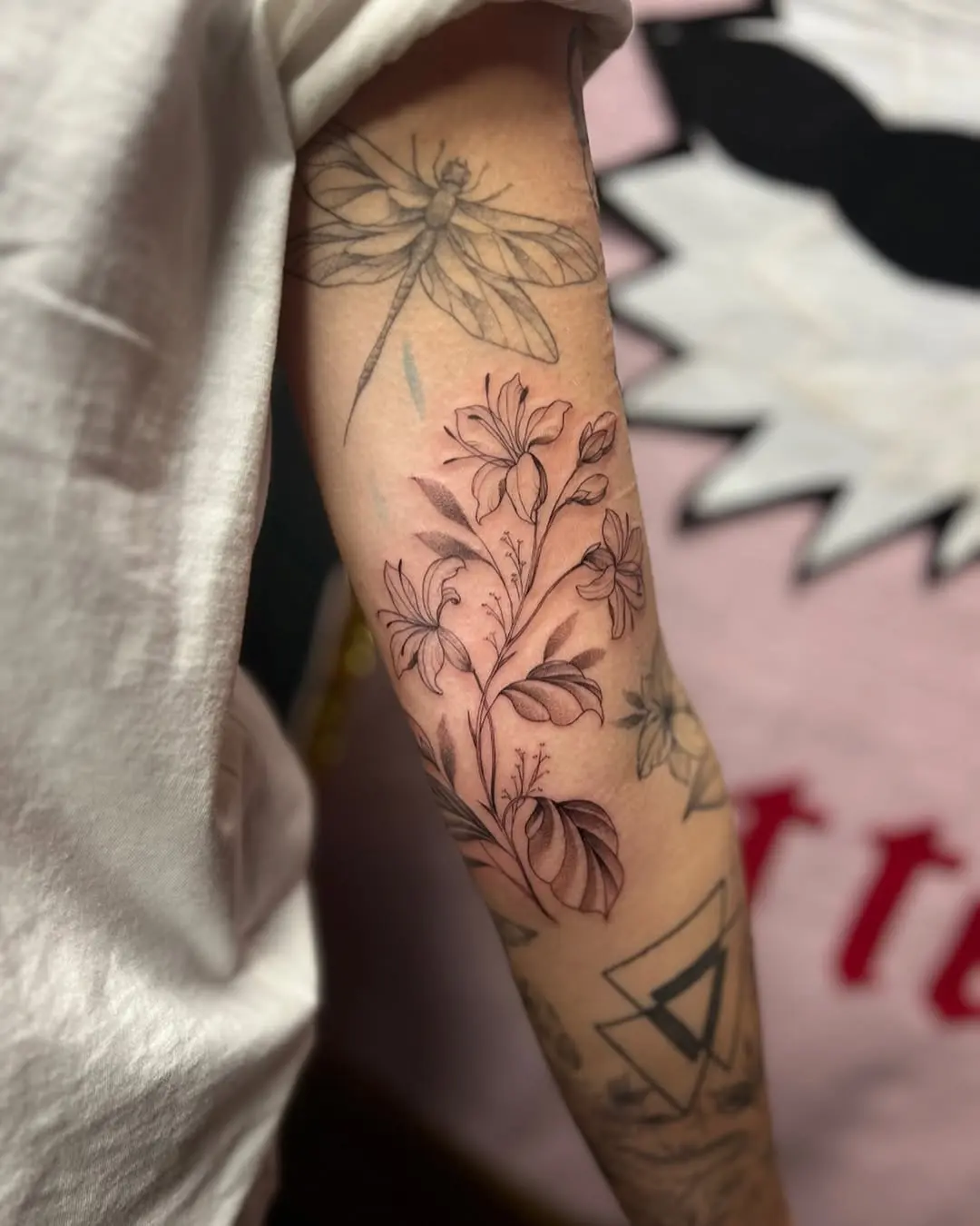 Elegant honeysuckle tattoo with botanical elements