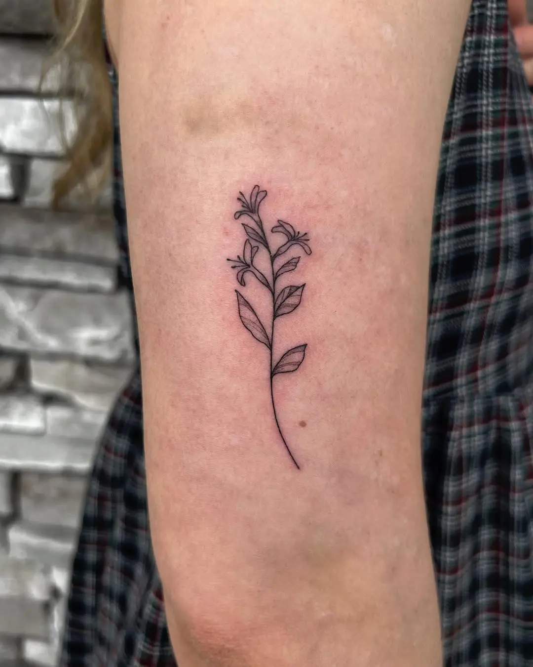 Elegant honeysuckle tattoo with delicate line art