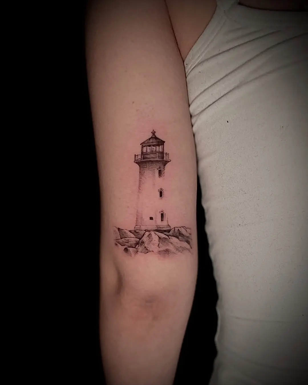 Realistic lighthouse tattoo on arm