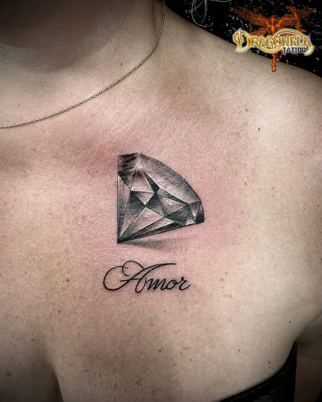 Elegant diamond tattoo with script lettering