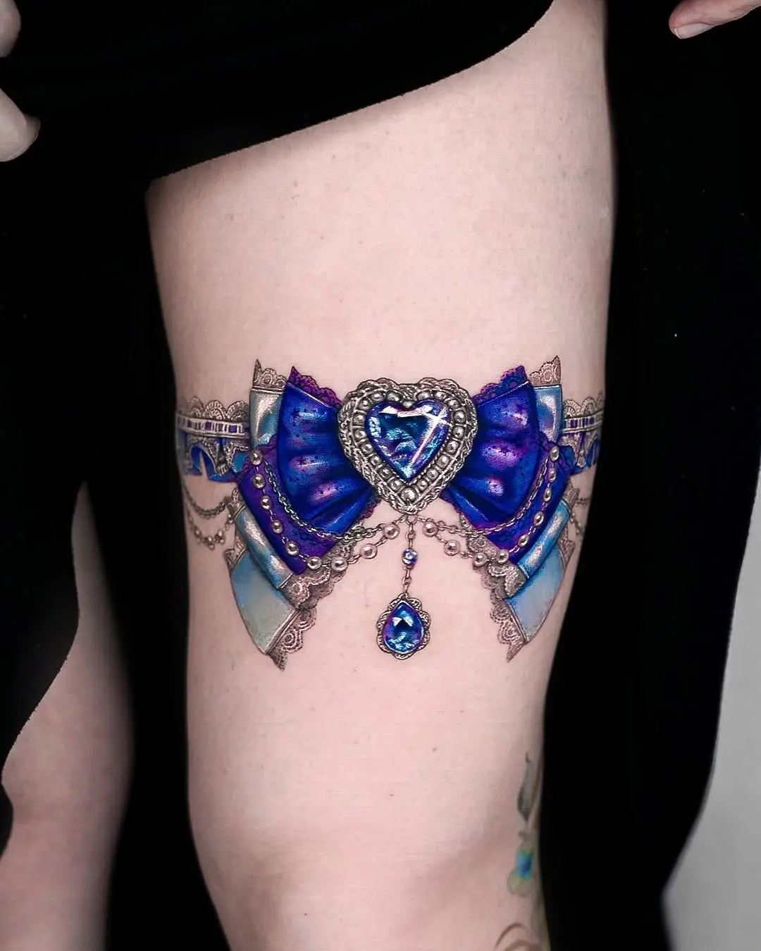 Exquisite bow-tie diamond tattoo on thigh