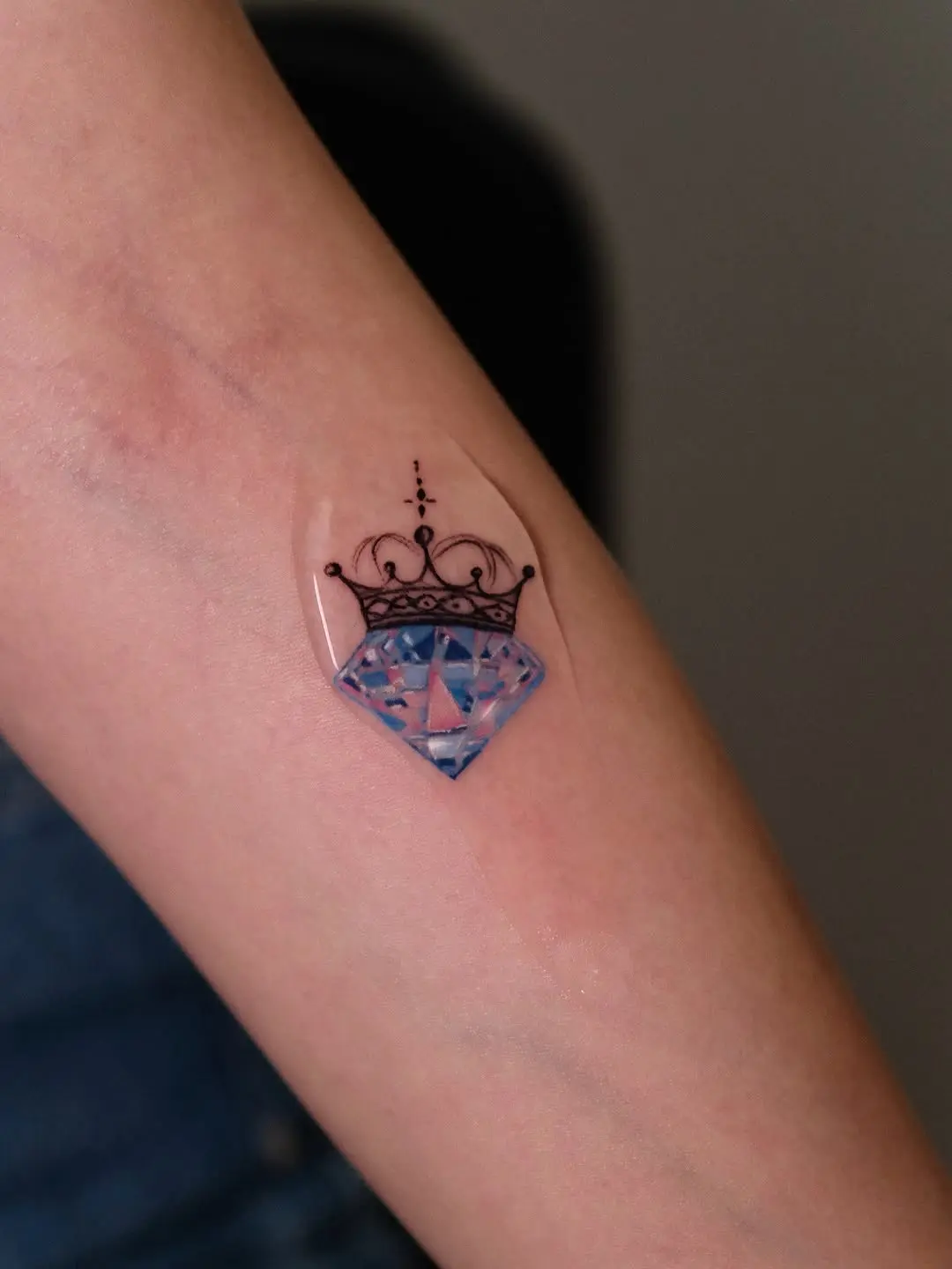 Elegant crown adorned diamond tattoo design