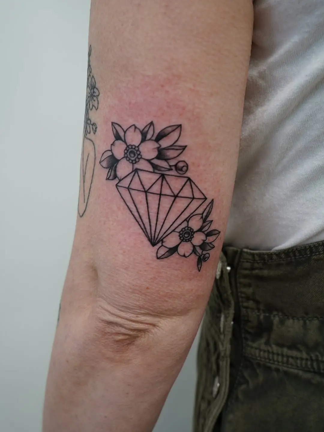 Elegant diamond tattoo with floral accents