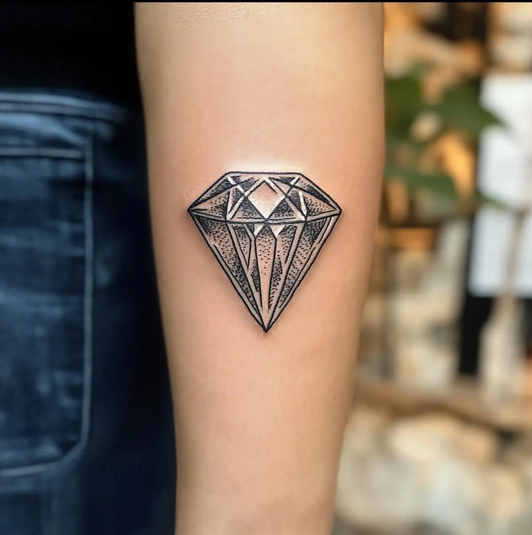 Stylish geometric diamond tattoo on the arm