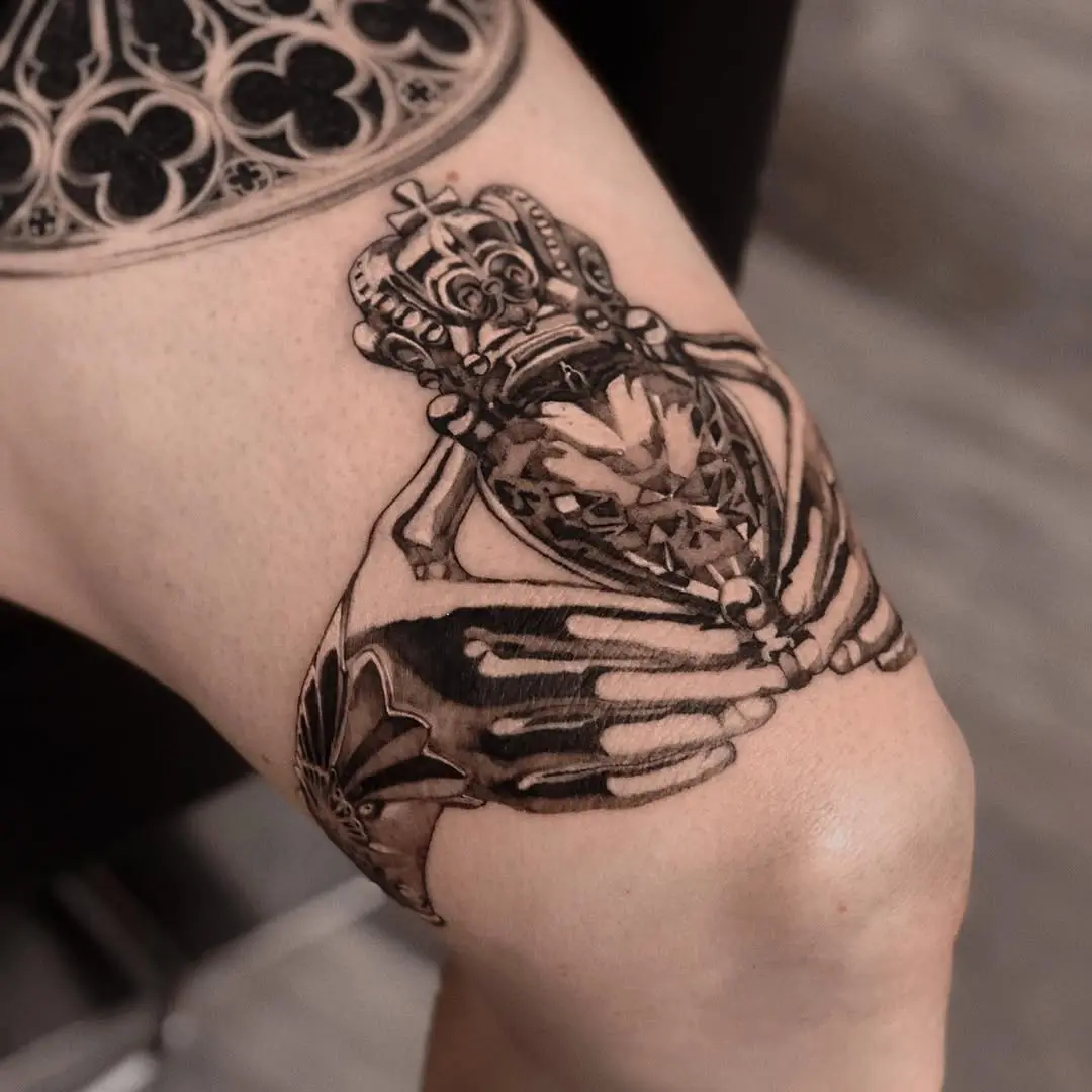 Intricate skeleton hand with diamond crown tattoo