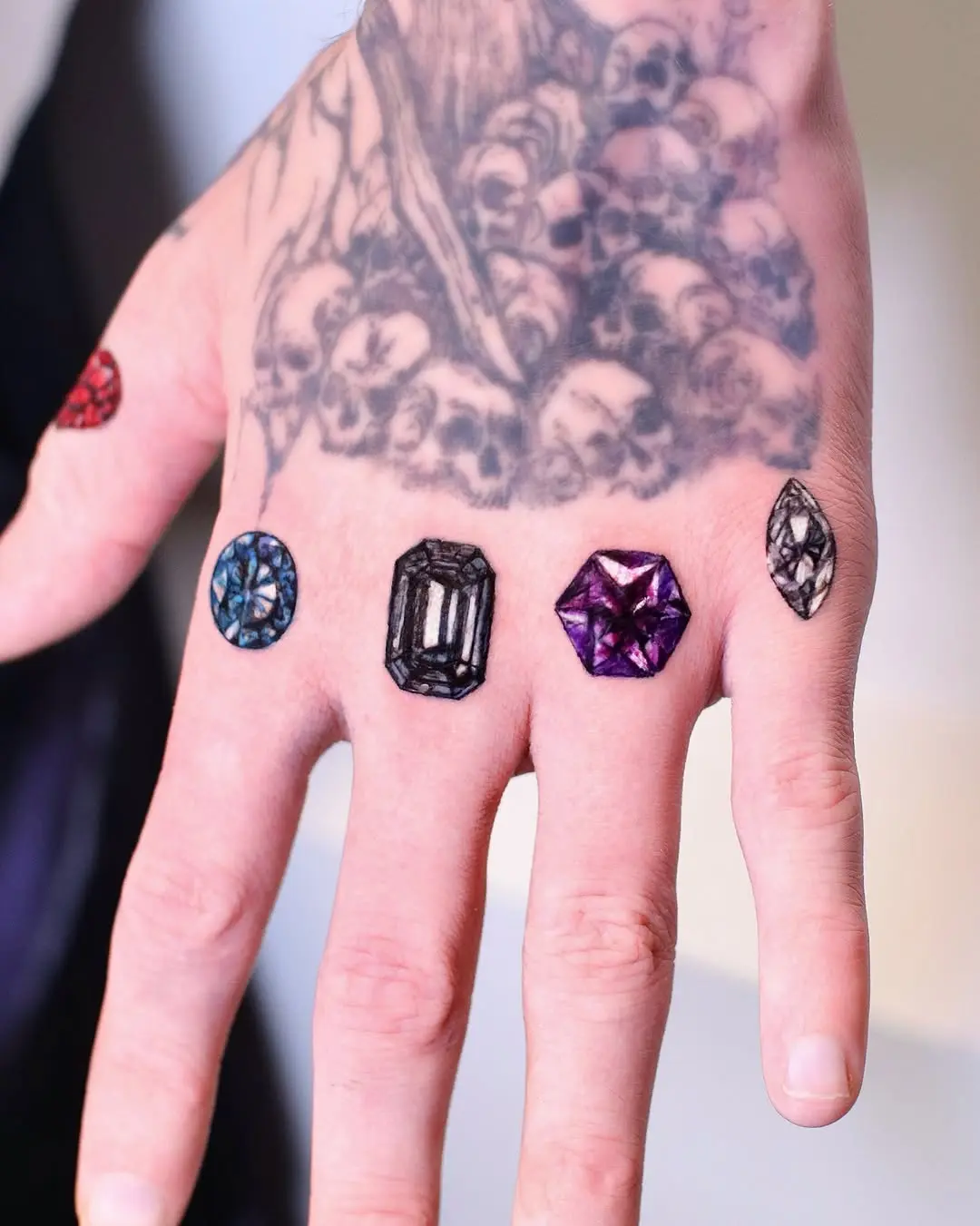 Unique diamond tattoos on an artistic hand