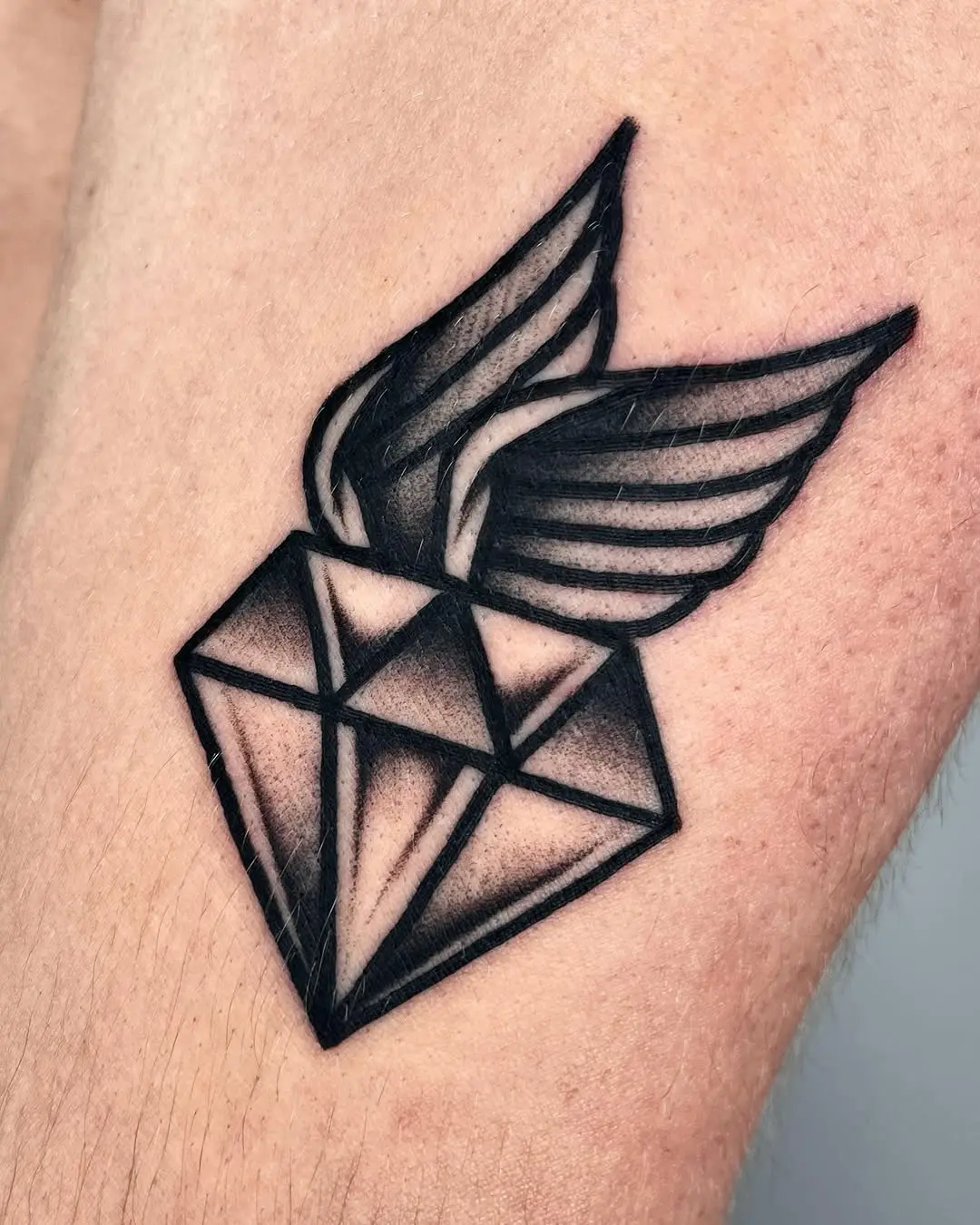 Stylish diamond tattoo with intricate wing detail