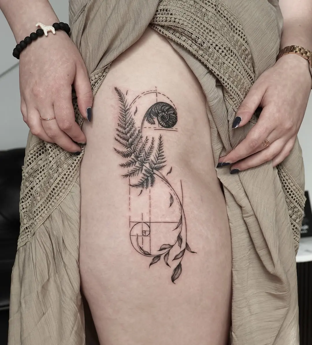 Nature-inspired Fibonacci fern tattoo on thigh